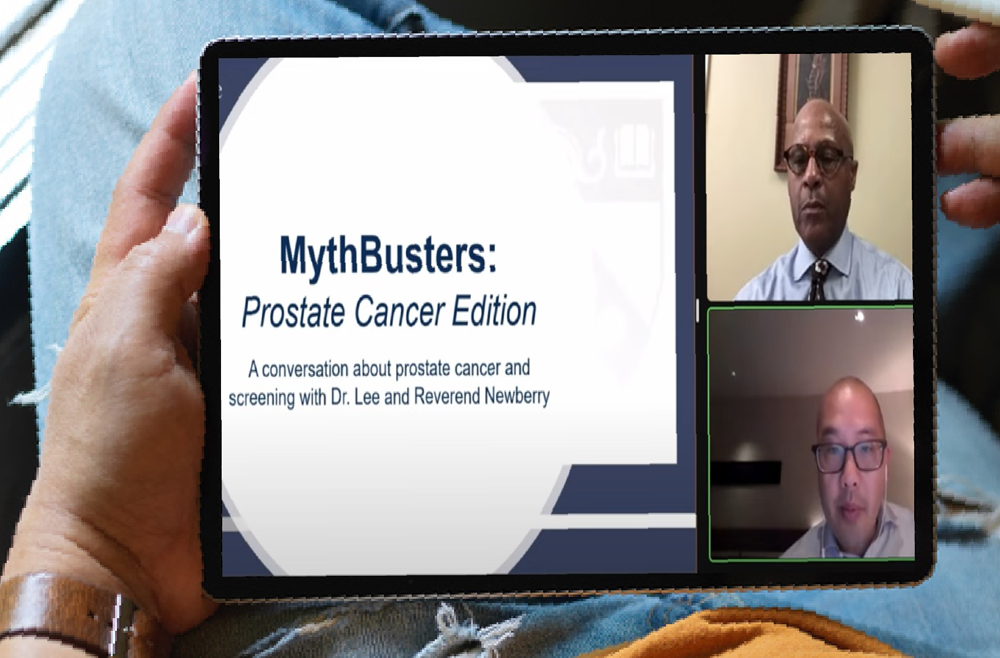 A person holding an iPad with a video on the screen titled, "MythBusters: Prostate Cancer Edition."